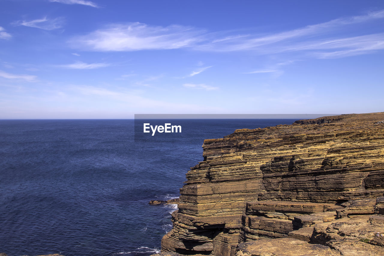 SCENIC VIEW OF SEA AGAINST ROCK FORMATION