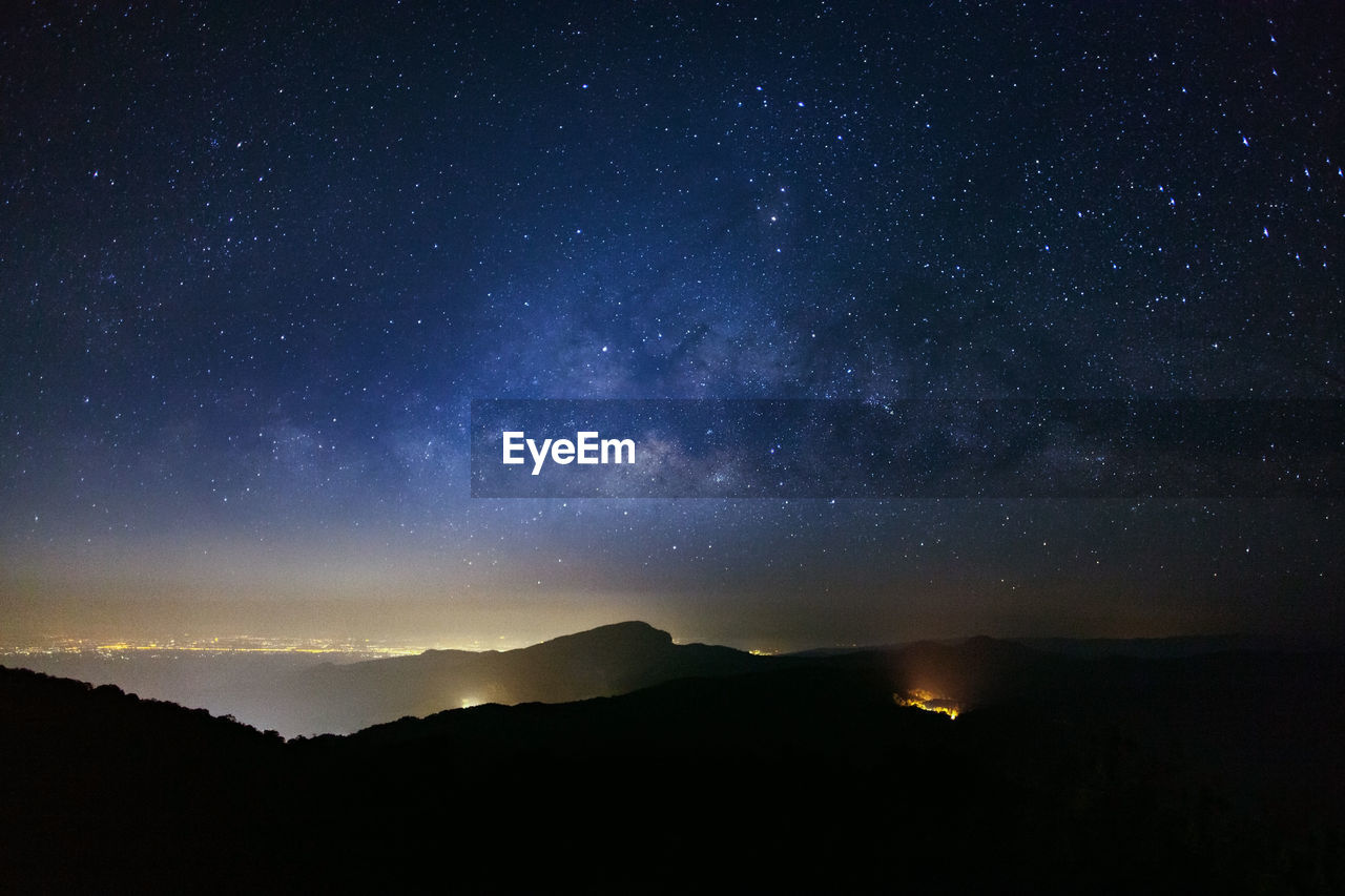 Scenic view of silhouette mountain against sky at night