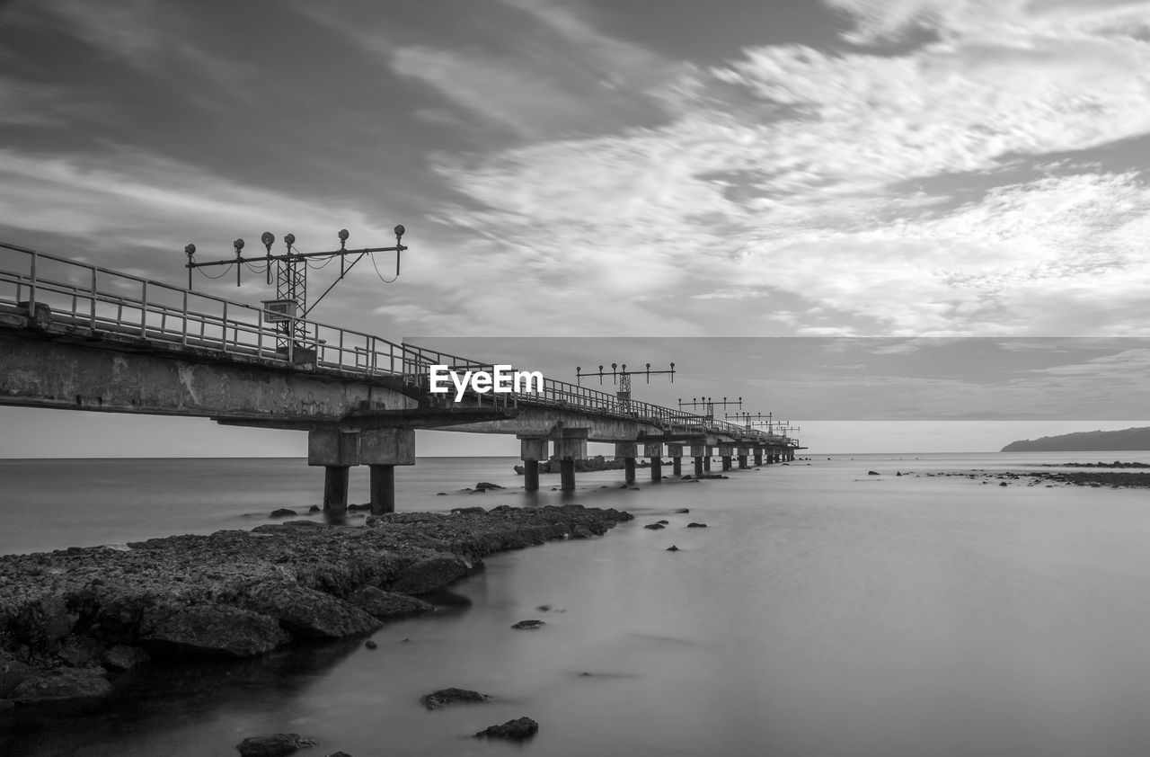 Pier over sea against sky