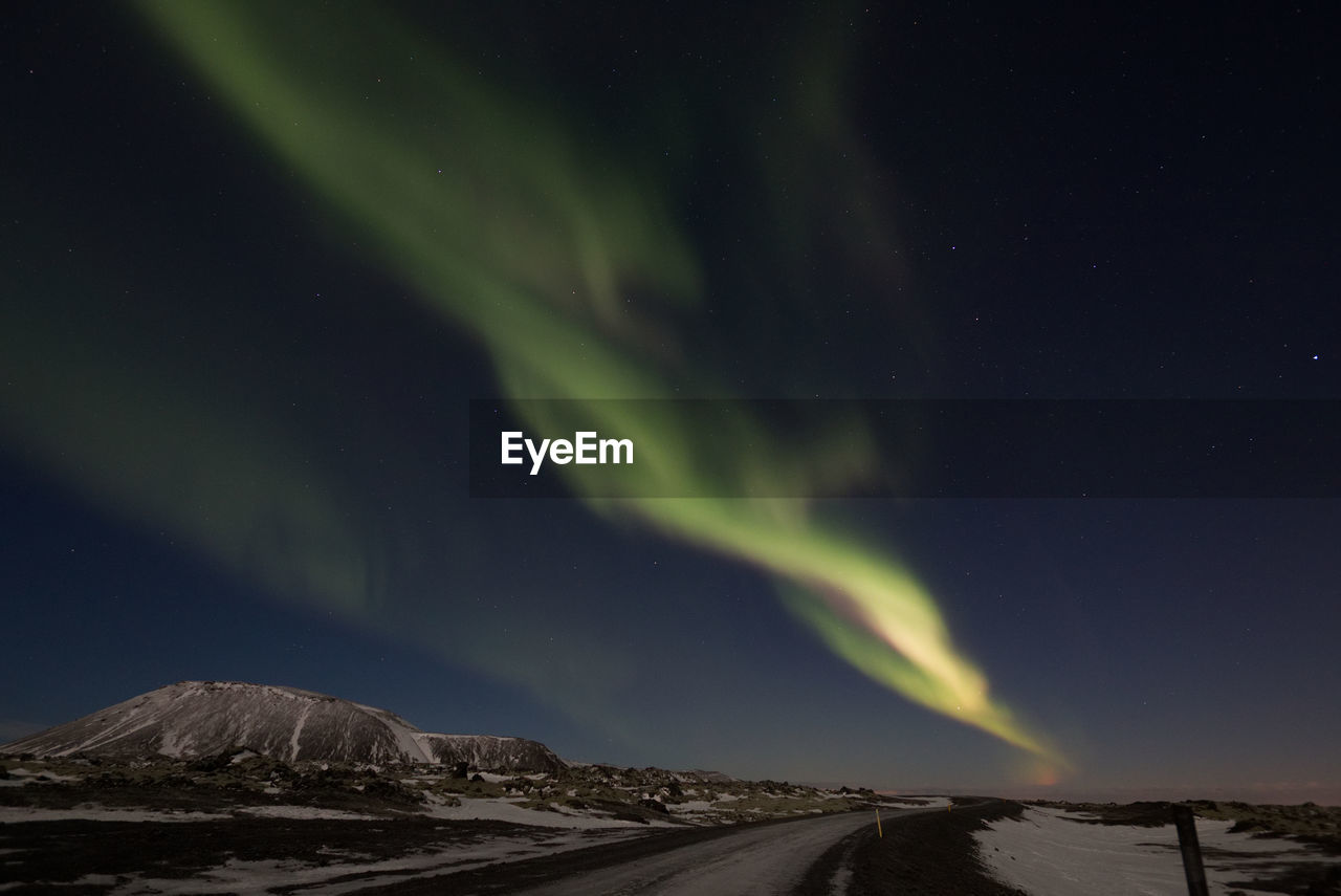 Scenic view of mountains against sky at night