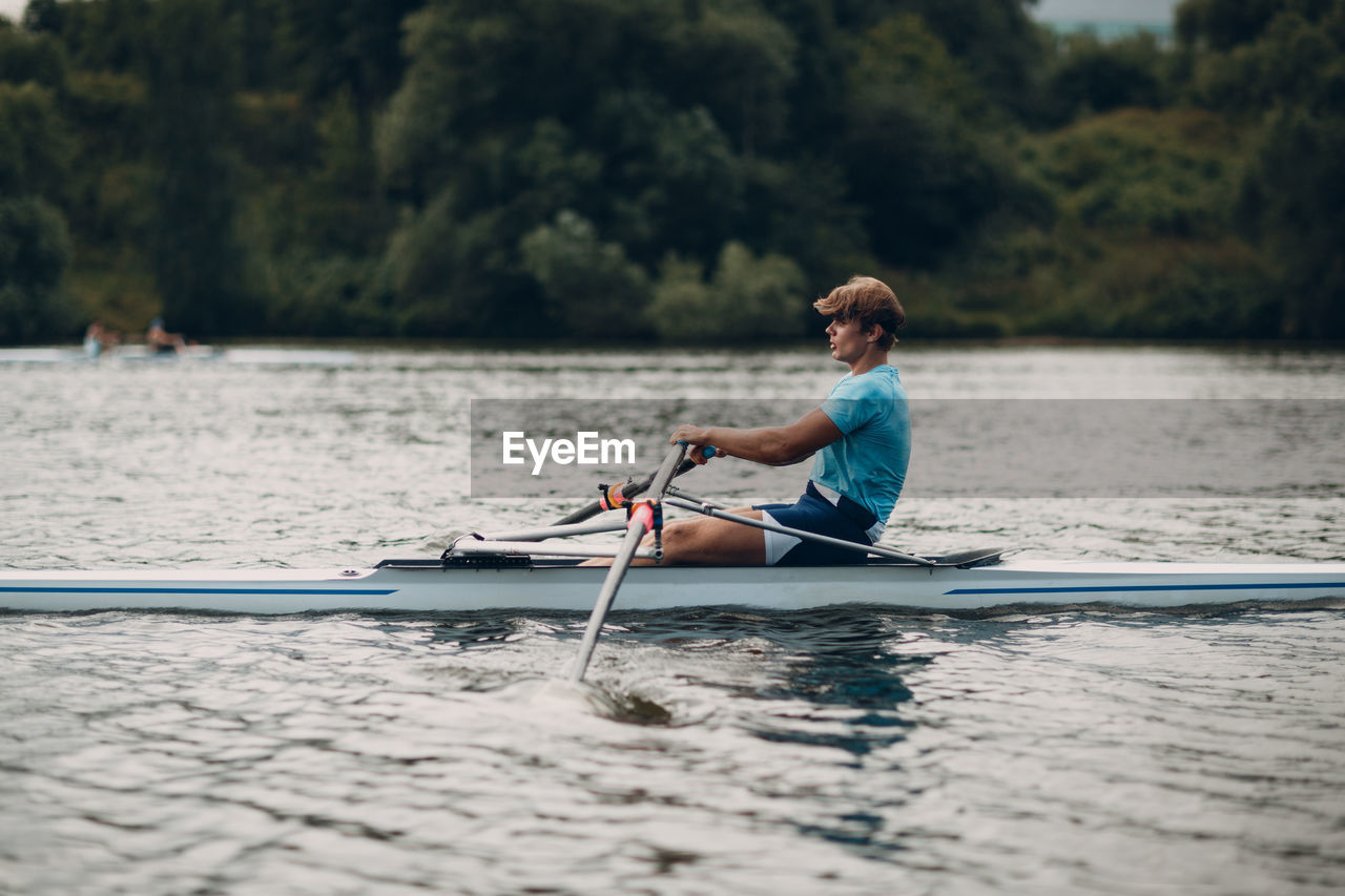 Man sitting in boat on lake