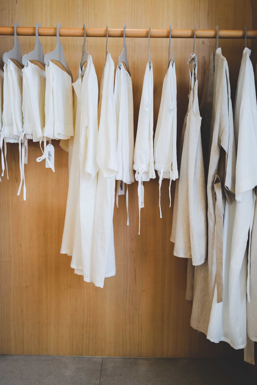 Neutral colored clothes on the rack at the shop