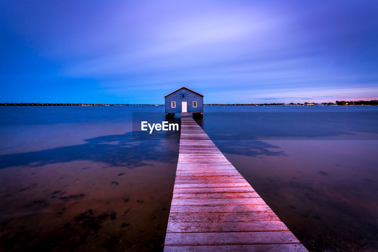 Jetty leading towards sea against sky