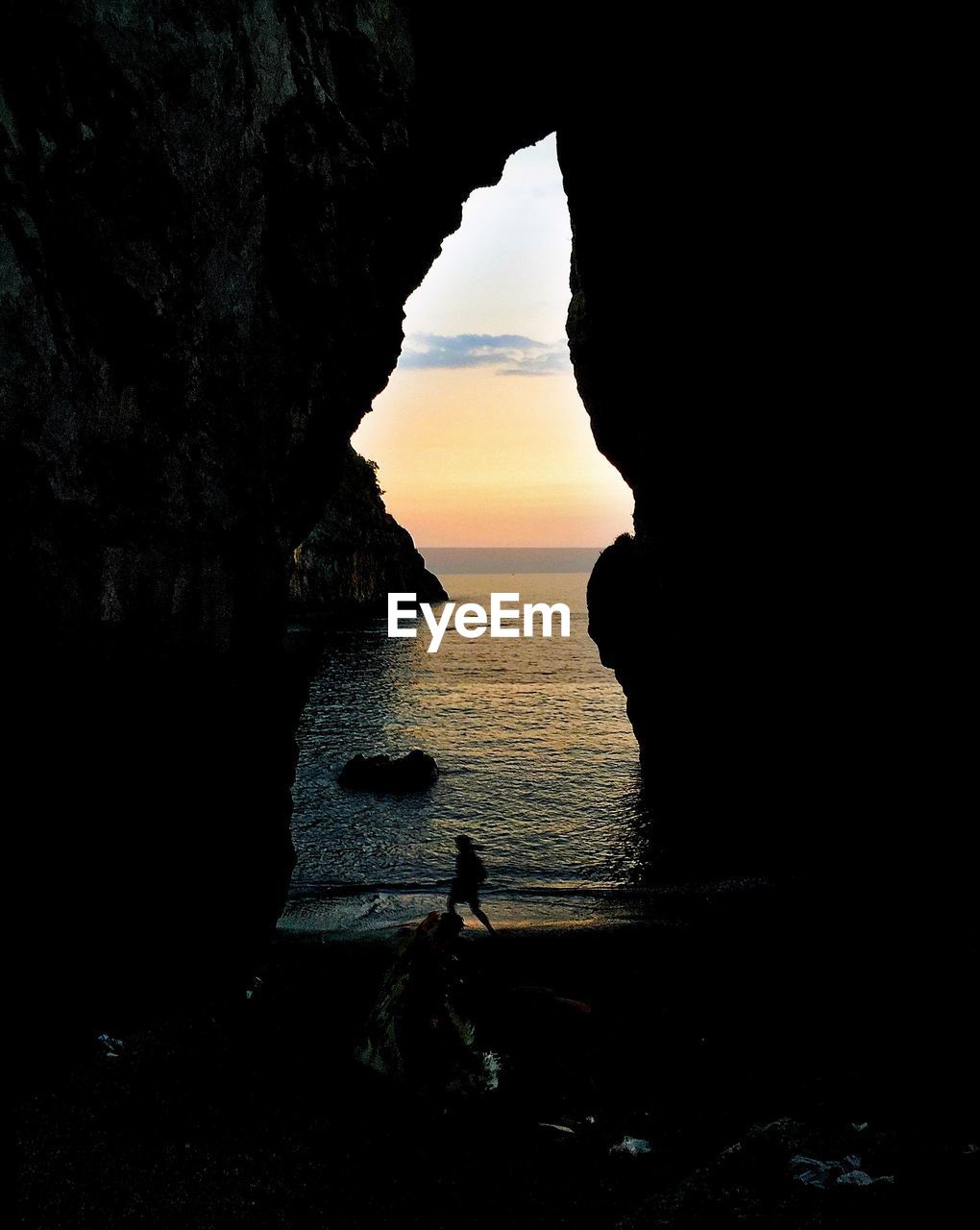 Silhouette of rock formations in sea