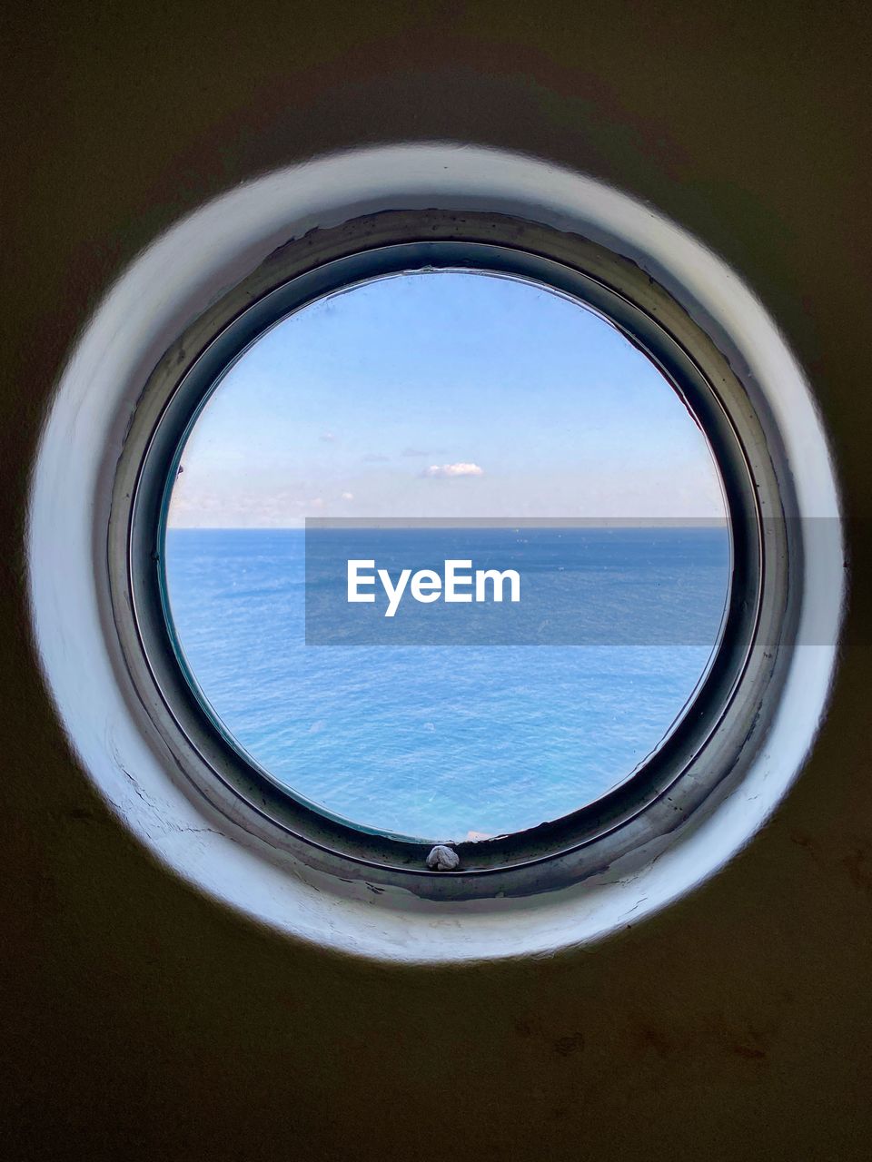 Scenic view of sea against sky seen through window