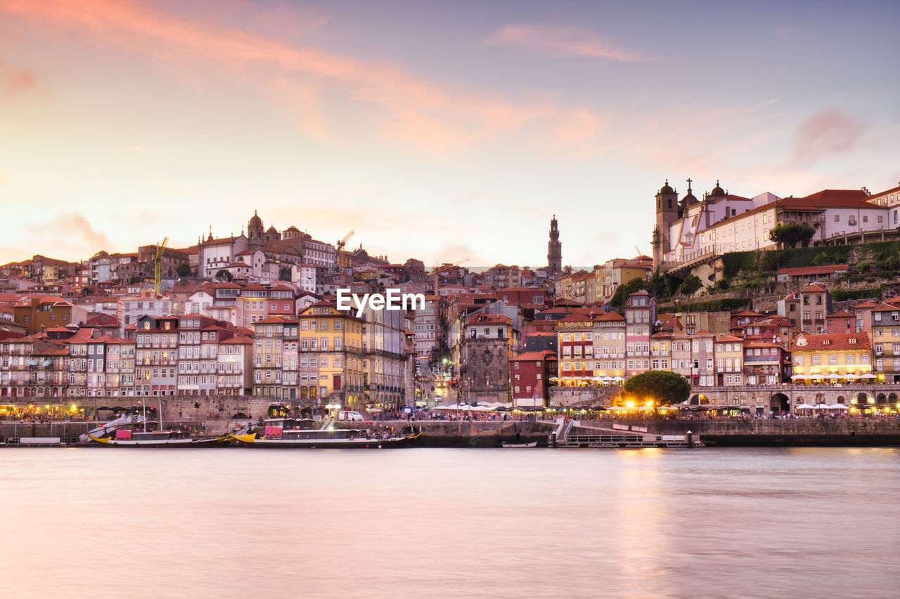 VIEW OF RIVER WITH BUILDINGS IN BACKGROUND