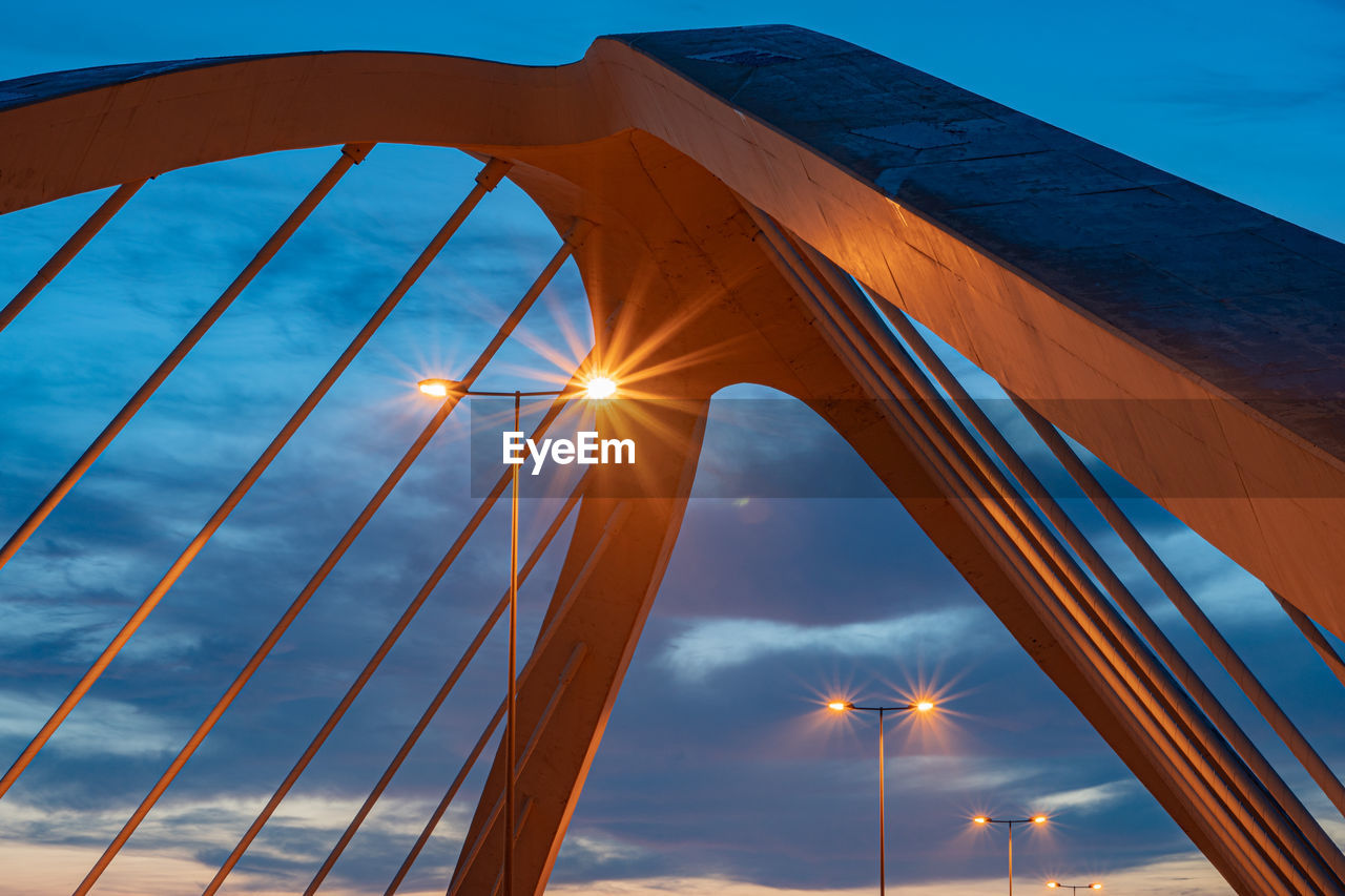 Low angle view of bridge against sky during sunset