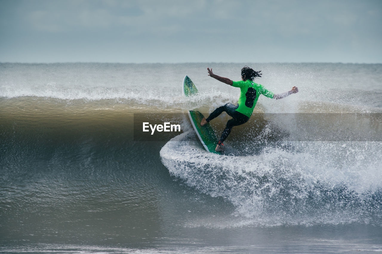 MAN SURFING IN SEA