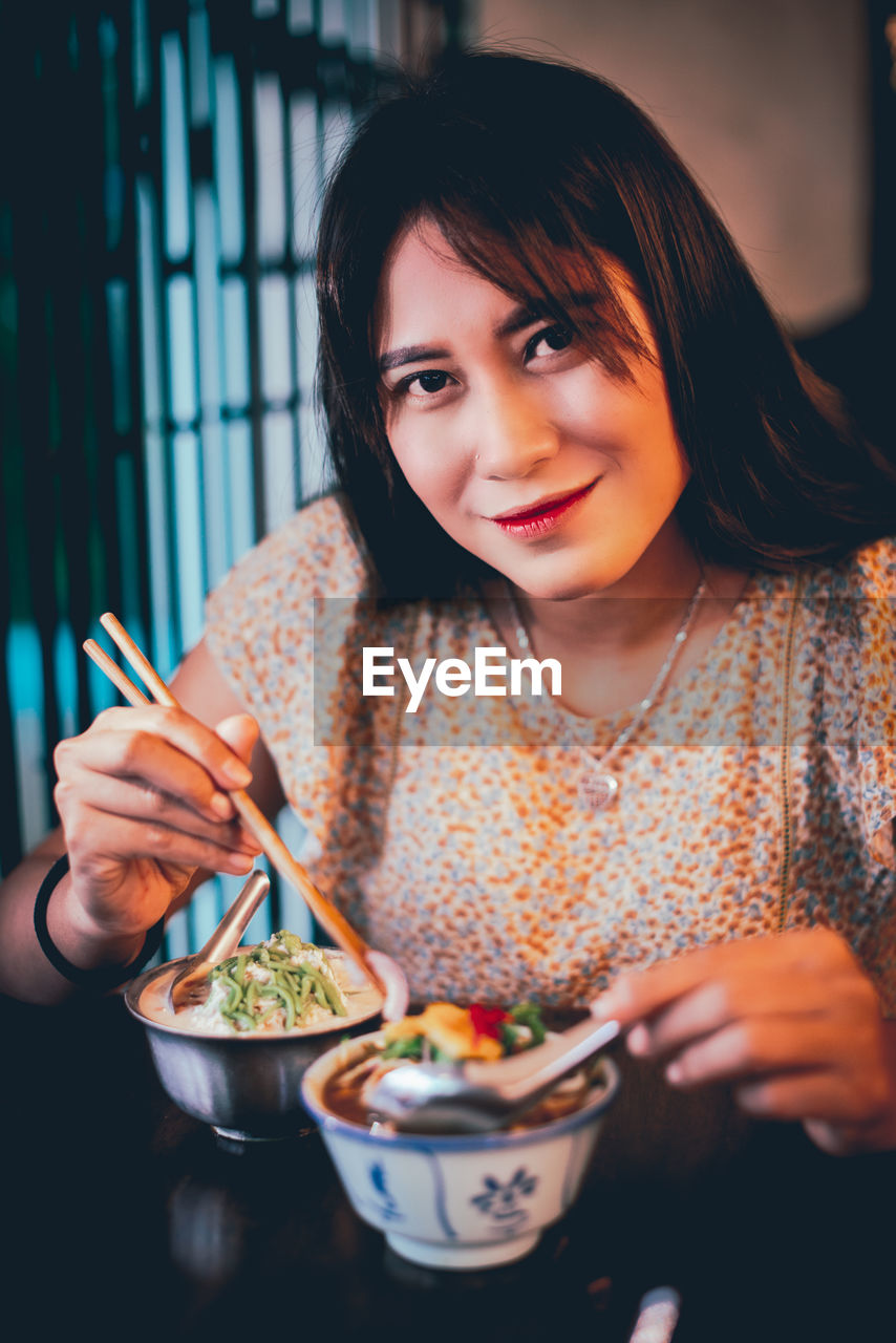 Portrait of woman eating food