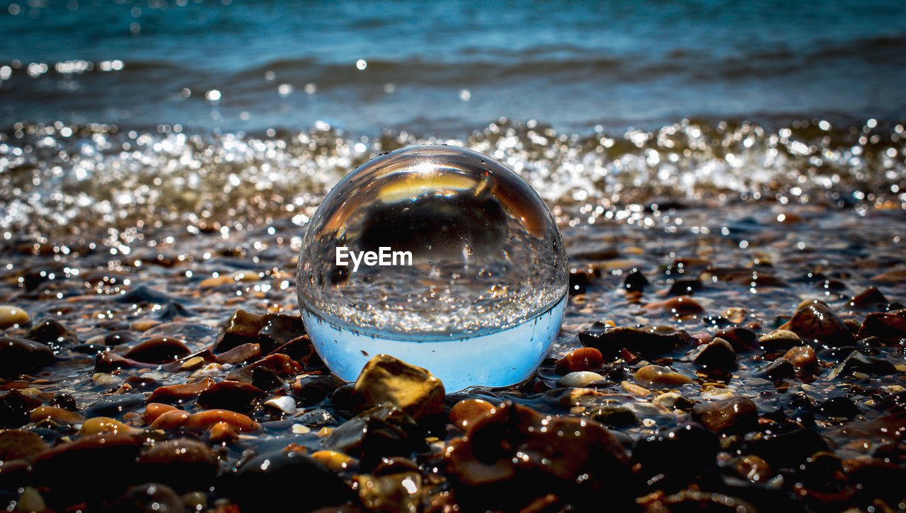 Close-up of crystal ball in the sea