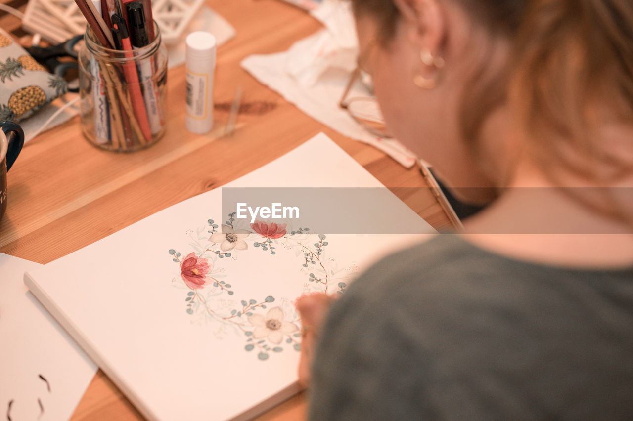 Close-up of girl drawing on table