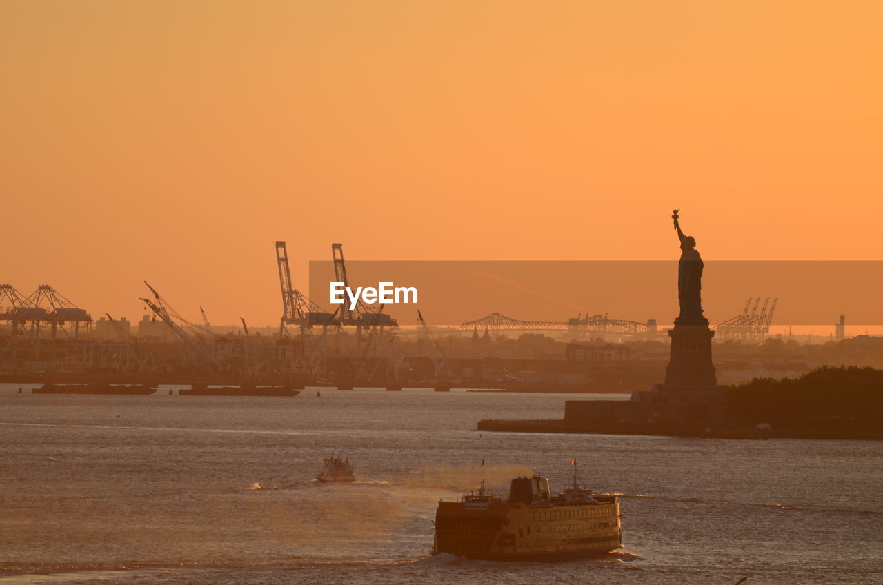 Statue of liberty against sky during sunset