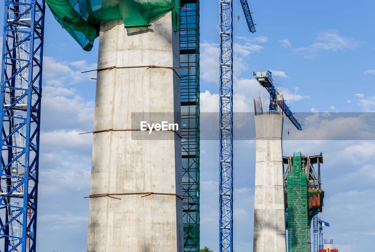 LOW ANGLE VIEW OF FACTORY AGAINST SKY