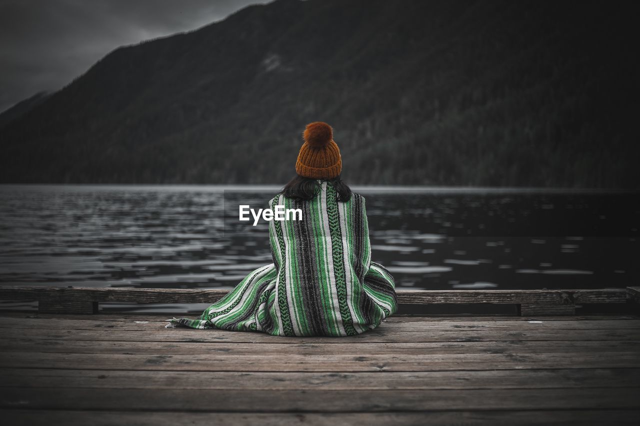 REAR VIEW OF WOMAN LOOKING AT LAKE