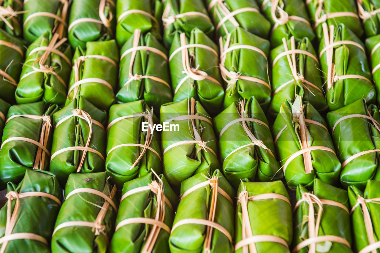 Full frame shot of food wrapped in banana leaves for sale at market stall
