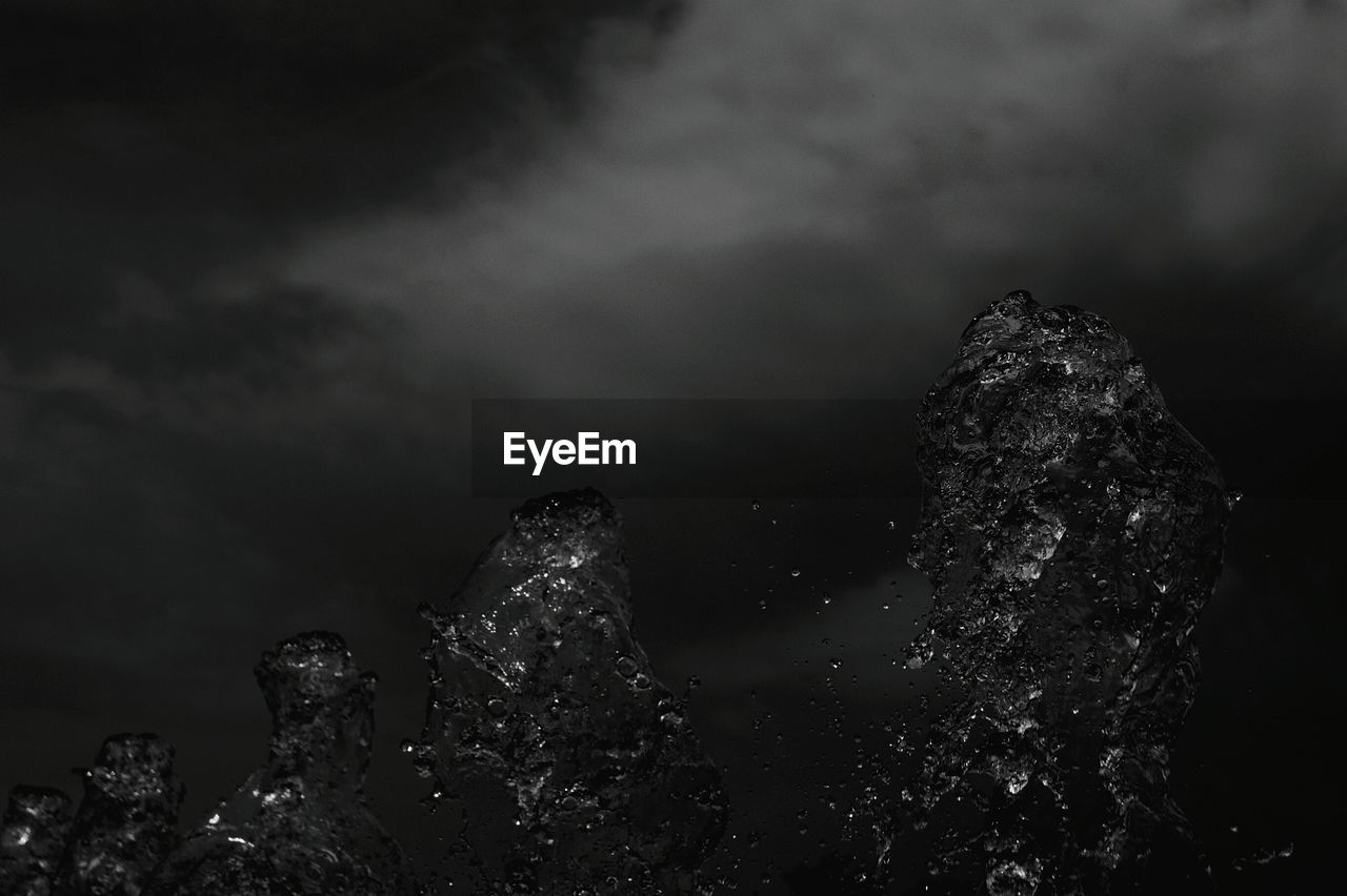 LOW ANGLE VIEW OF ROCK FORMATIONS AGAINST SKY