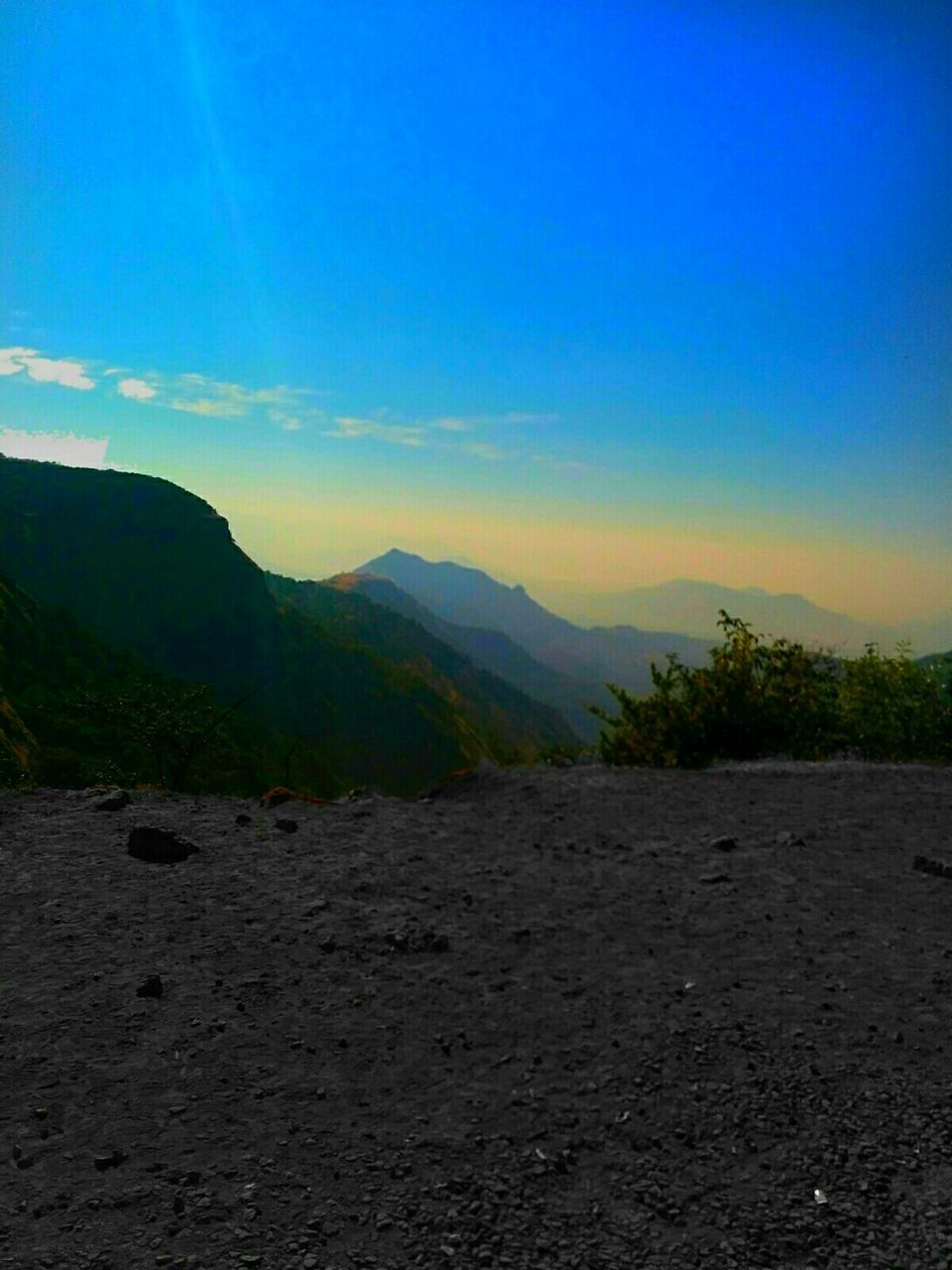 SCENIC VIEW OF MOUNTAINS AT SUNSET