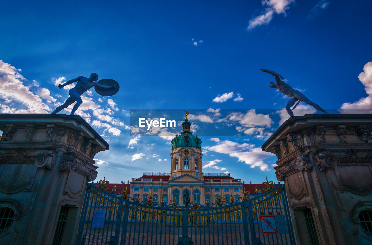 View of charlottenburg palace from the entrance gate. photographed from a horizontal perspective.