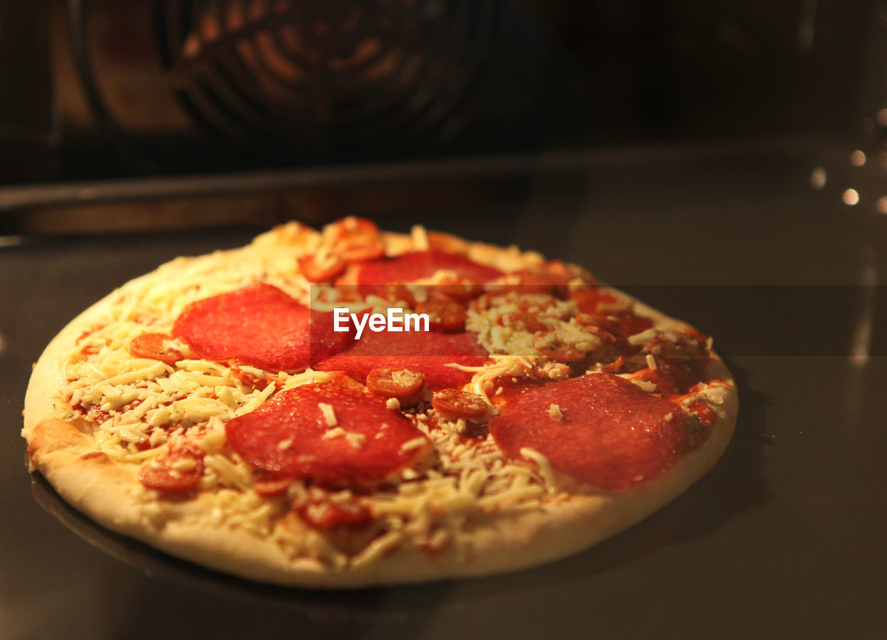 CLOSE-UP OF PIZZA WITH SAUCE IN PLATE