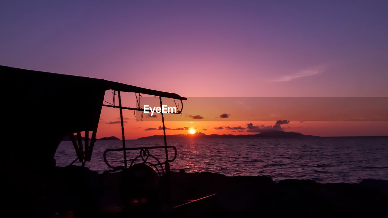 SCENIC VIEW OF SEA AGAINST ORANGE SKY