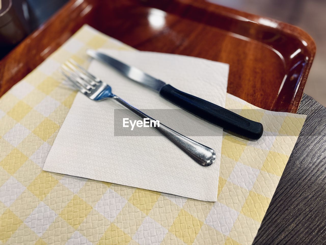 indoors, table, fork, no people, household equipment, kitchen utensil, business, high angle view, eating utensil, wood, table knife, knife, close-up, still life, furniture, tablecloth, paper, food and drink, napkin