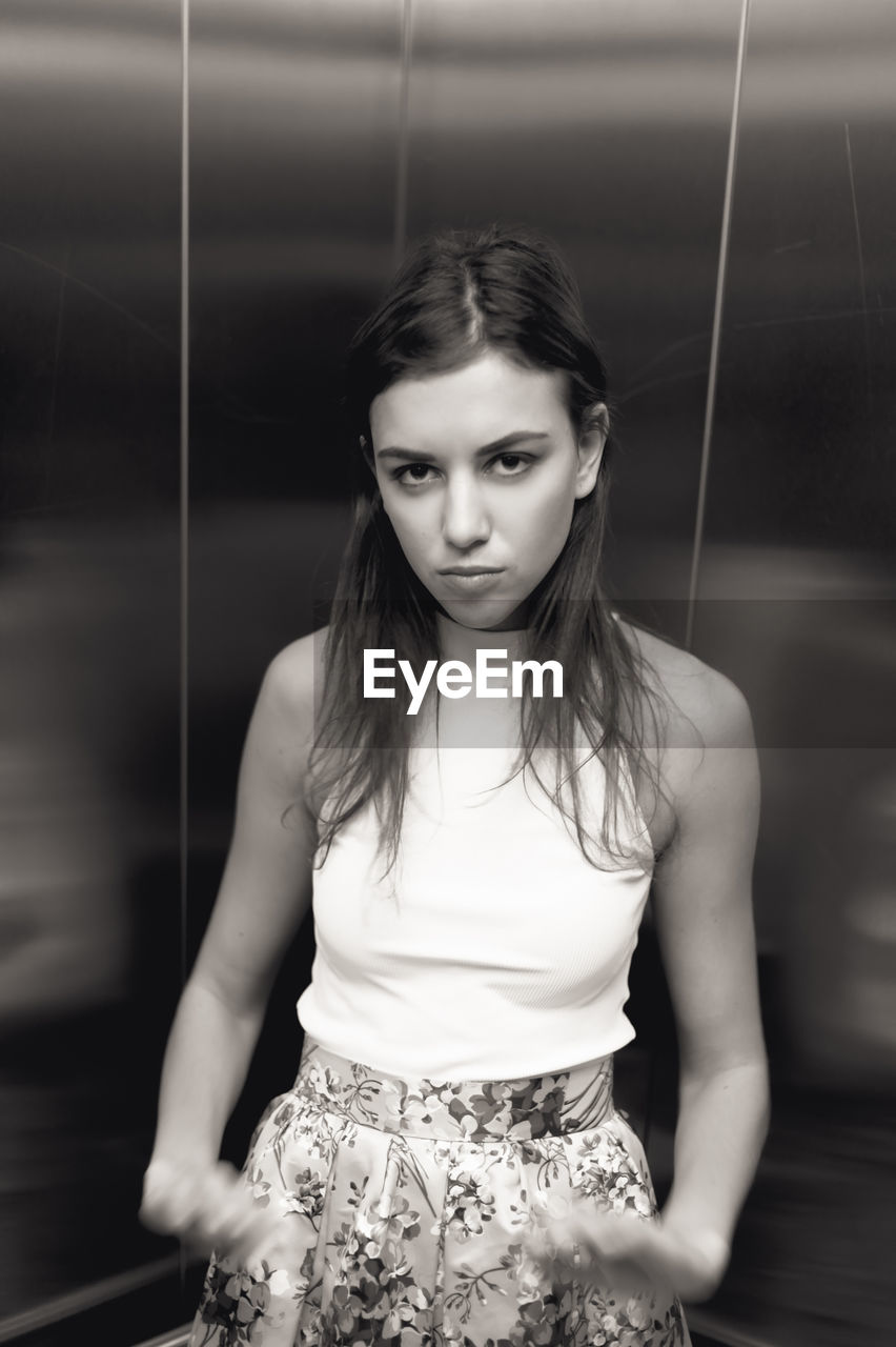 Portrait of beautiful young woman in elevator