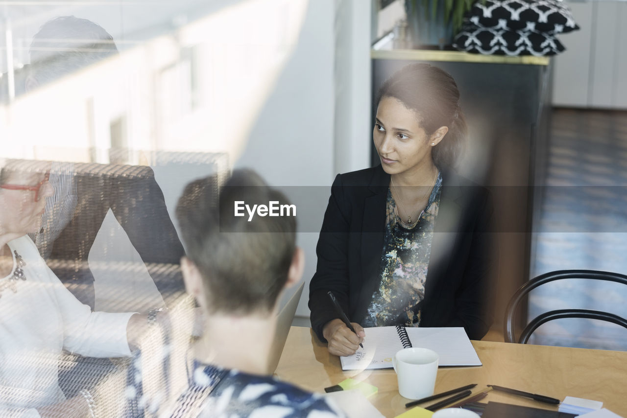 Business man and women discussing in board room