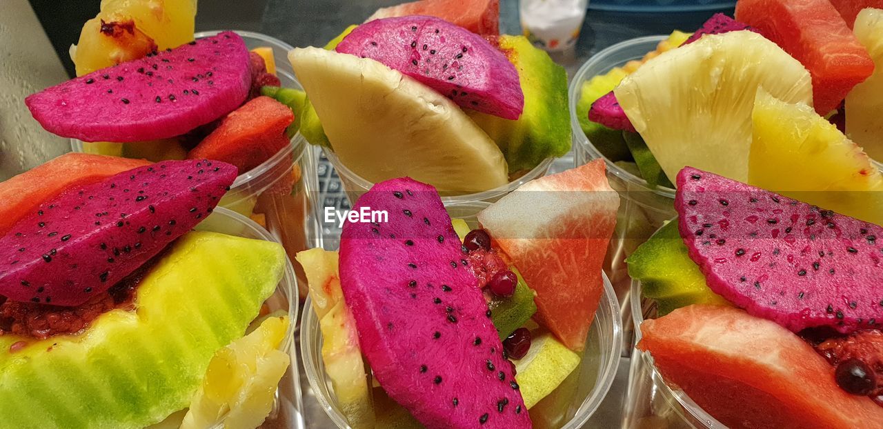 HIGH ANGLE VIEW OF MULTI COLORED FRUITS IN PLATE