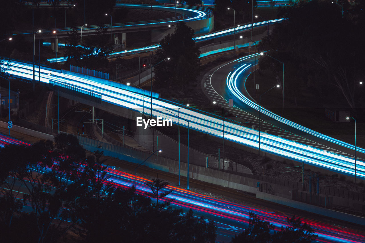 HIGH ANGLE VIEW OF LIGHT TRAILS ON ROAD