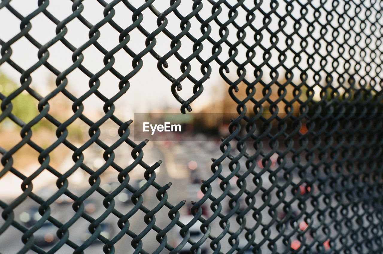 Close-up of chainlink fence against sky