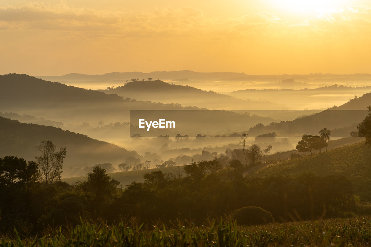 Scenic view of landscape against sky during sunrise