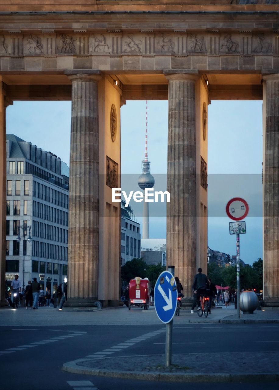 People at brandenburg gate against fernsehturm