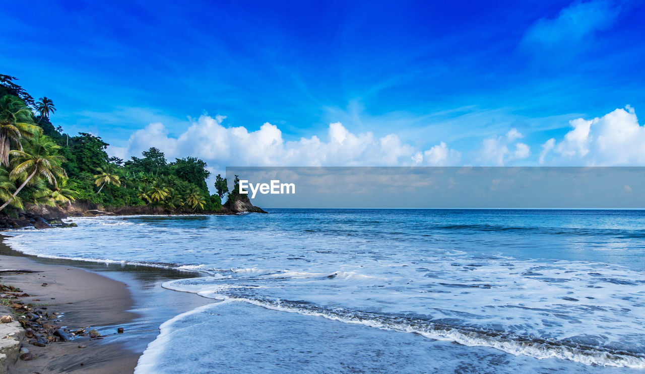 Scenic view of sea against blue sky