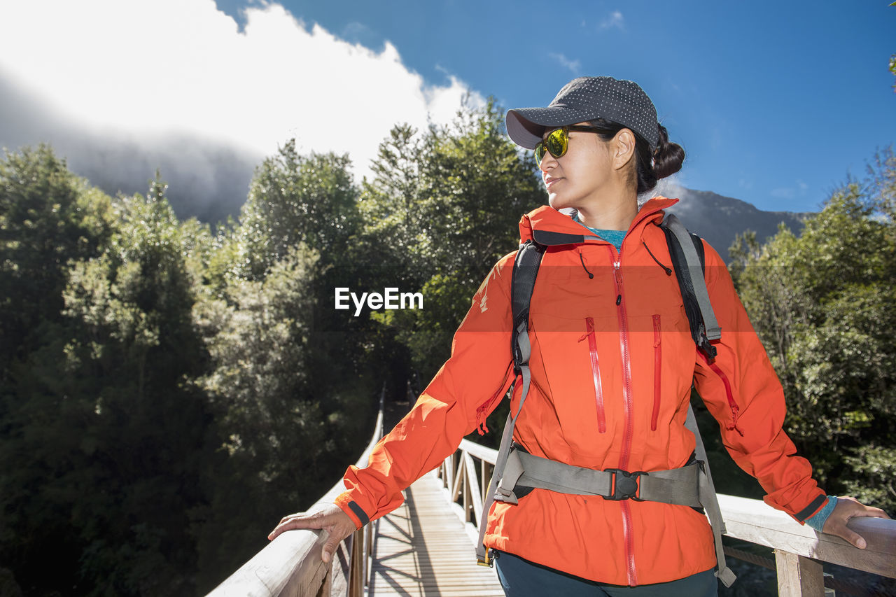 Woman crossing wooden bridge at caleta gonzalo in chile