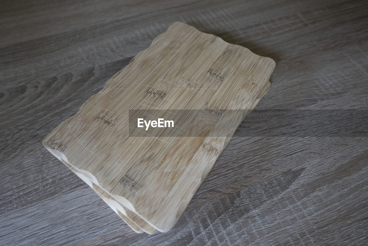 High angle view of cutting boards on wooden table