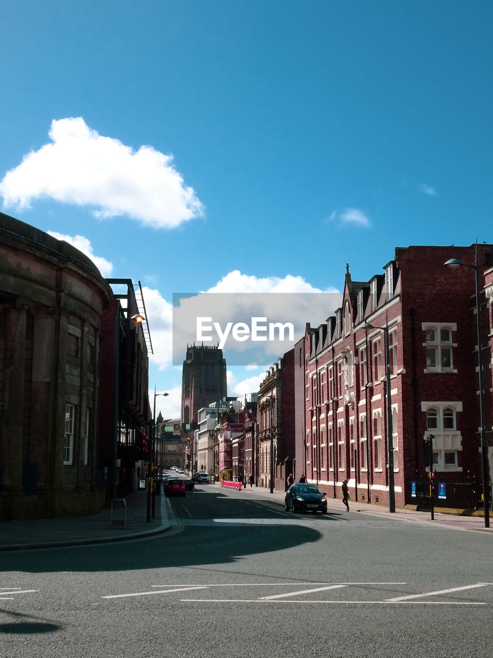 Street amidst buildings in city against sky