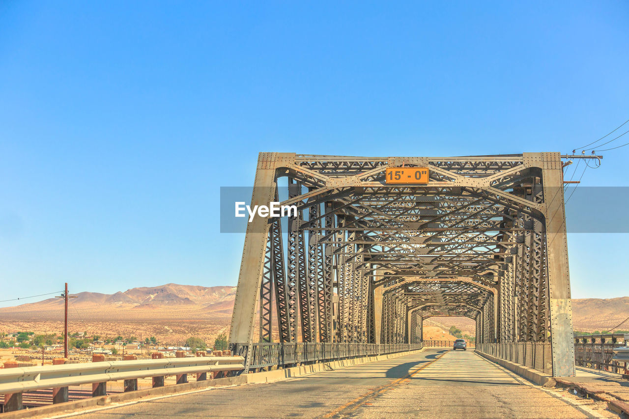 BRIDGE AGAINST BLUE SKY