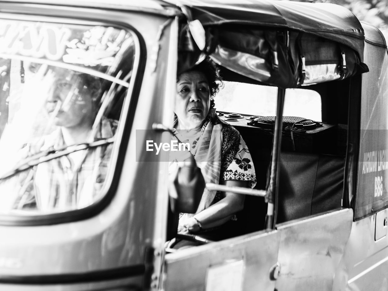 PORTRAIT OF SENIOR MAN SITTING IN CAR