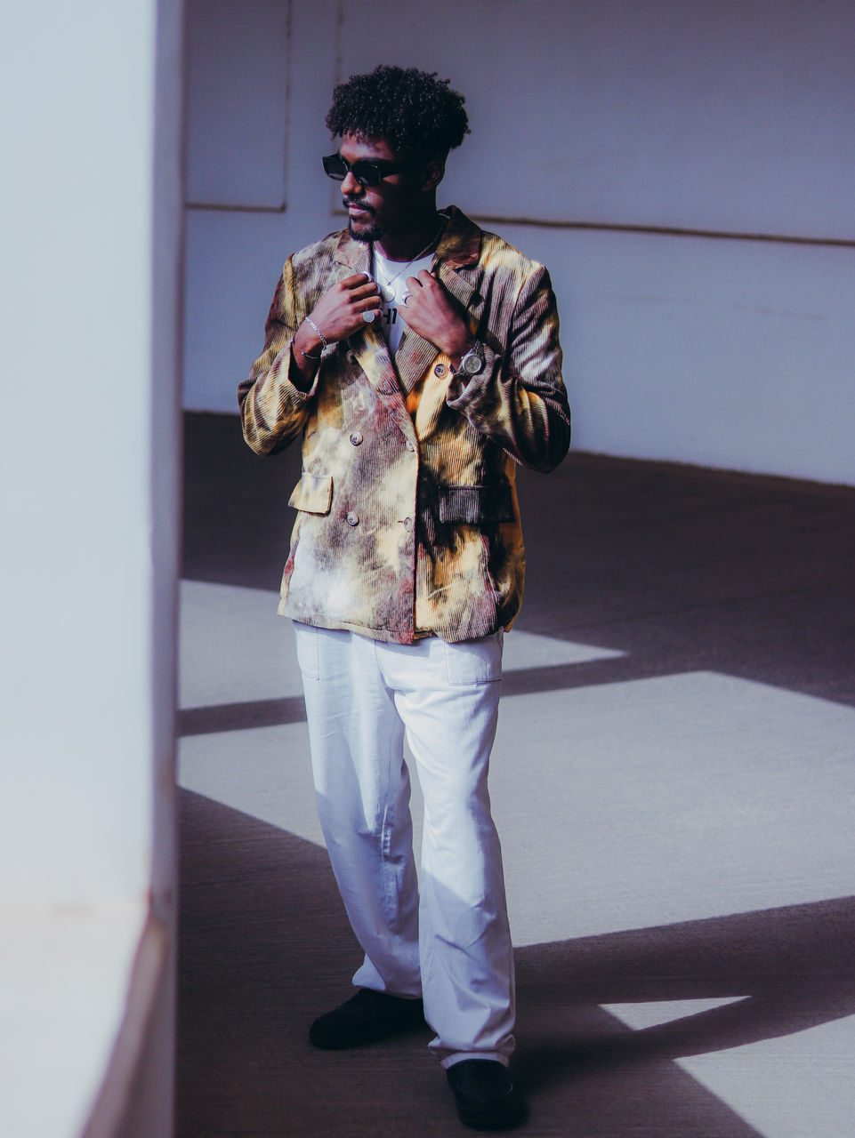 Rear view of young man standing against wall