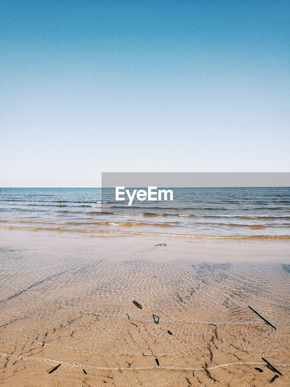 Scenic view of beach against clear sky