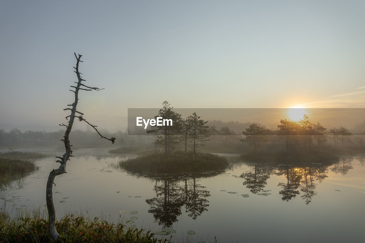 Scenic view of lake against sky during sunset