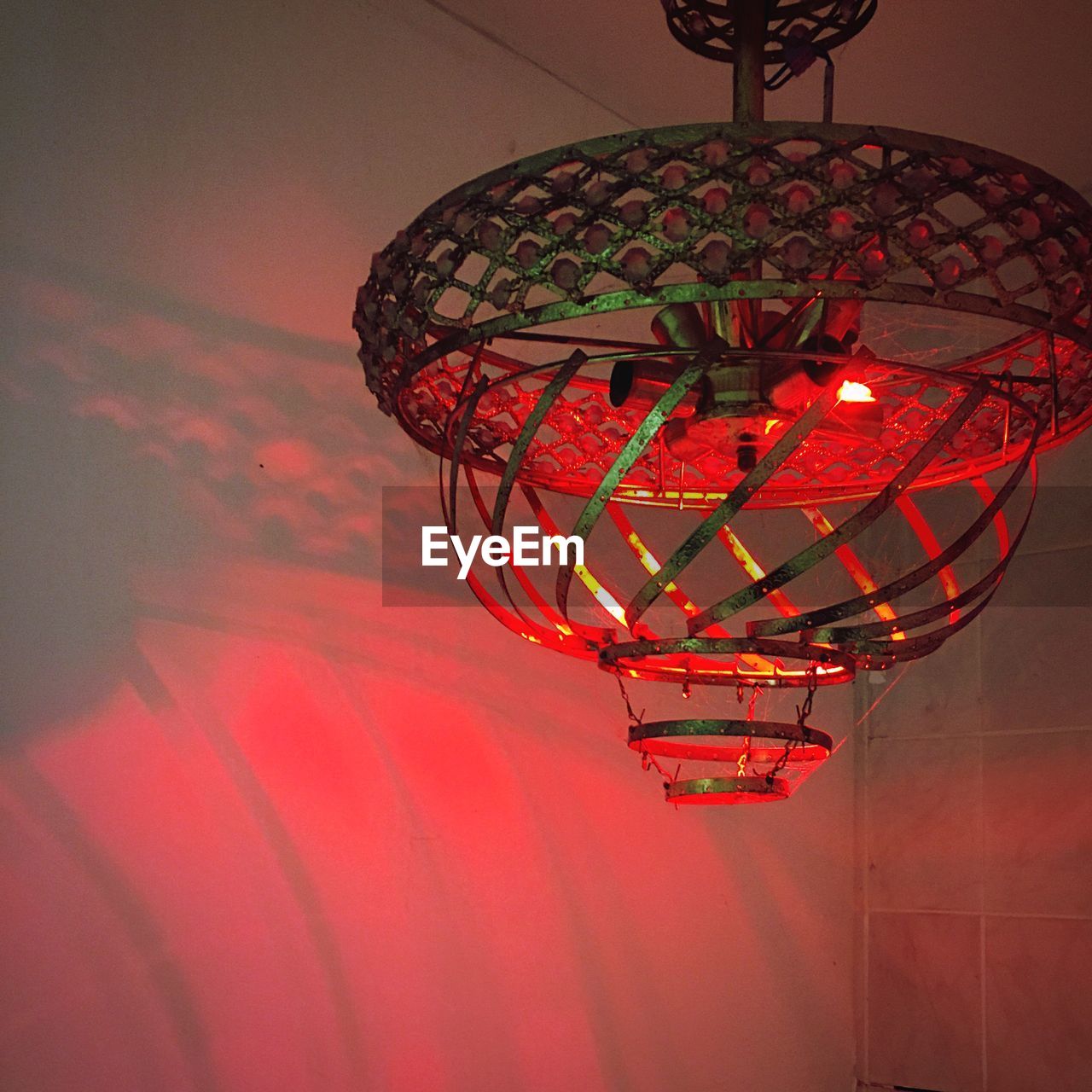Low angle view of illuminated lantern against ceiling