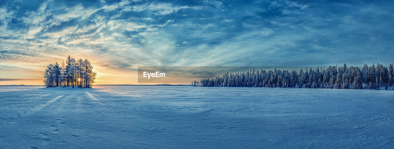 Scenic view of snow covered land against sky