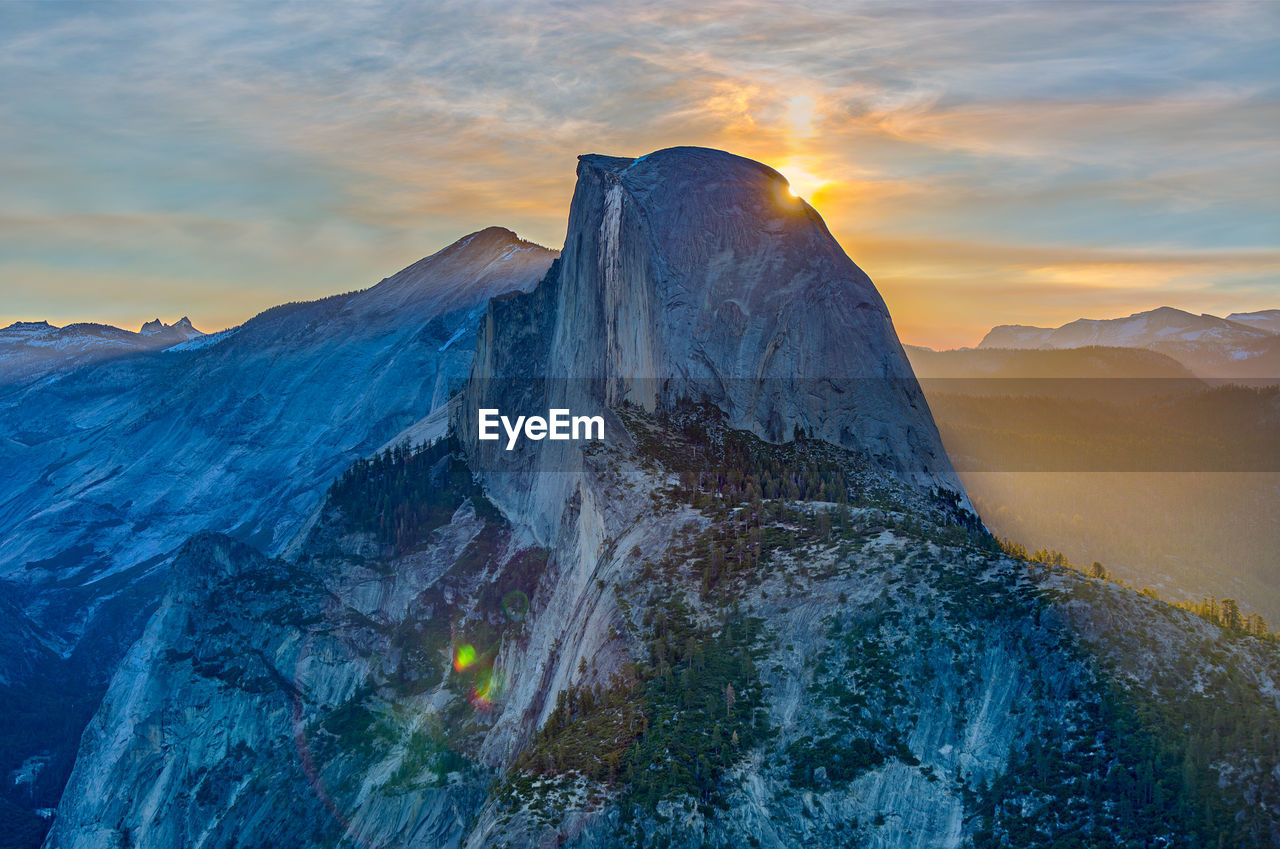 Scenic view of half dome mountain against sky at sunrise