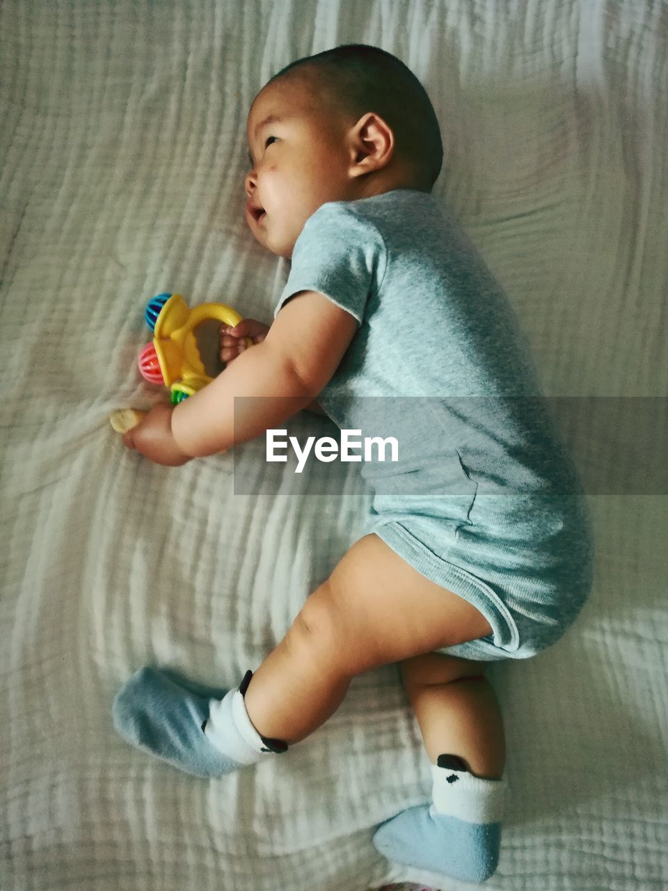 BOY WITH BABY GIRL IN BLANKET