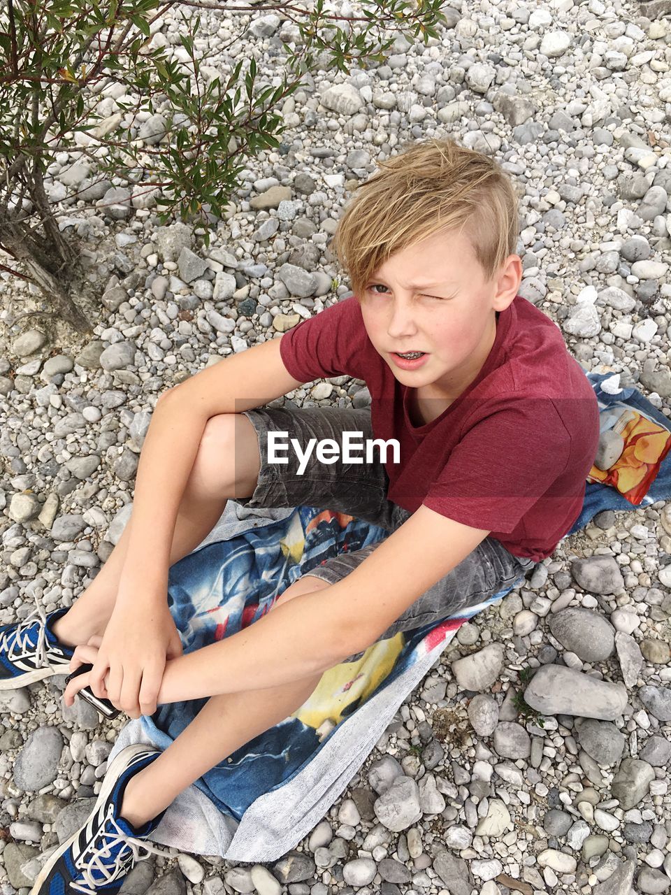 Young boy sitting on rocks