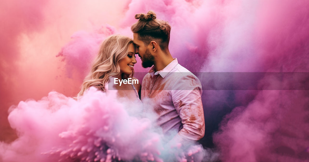 smoke, adult, two people, emotion, positive emotion, women, young adult, pink, togetherness, happiness, enjoyment, love, event, men, smiling, arts culture and entertainment, celebration, fun, romance, cheerful