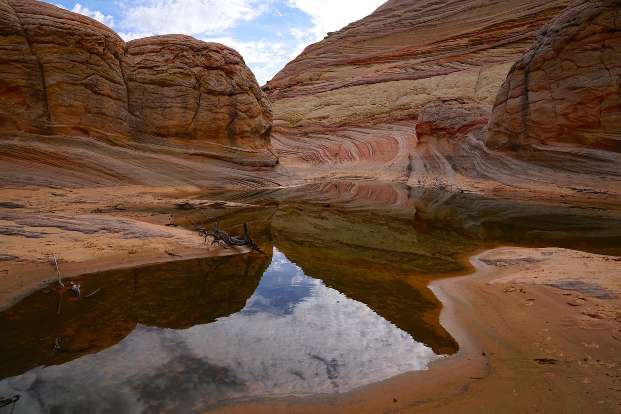 Scenic view of rock formations against cloudy sky