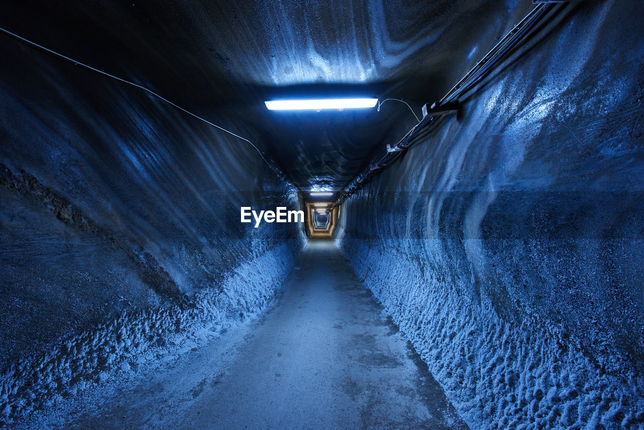 ILLUMINATED TUNNEL WITH LIGHT IN BACKGROUND