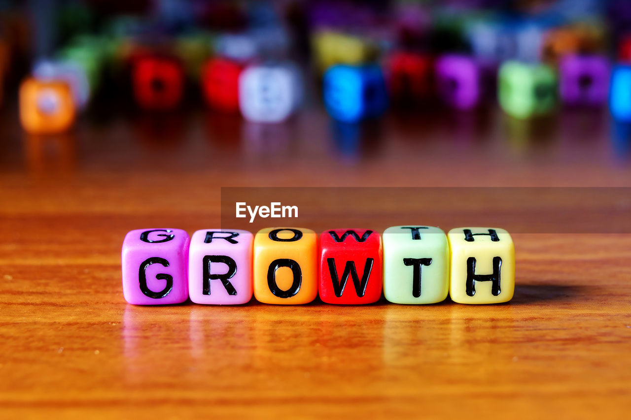 Close-up of text on multi colored toy blocks table